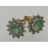 A pair of emerald and white stone cluster ear studs, the butterflies stamped 9ct.