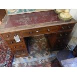 A late Victorian mahogany pedestal desk with leather inset top over central drawer flanked by 8