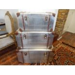A set of three Globe Trekker style wood and leather bound riveted aluminium trunks,