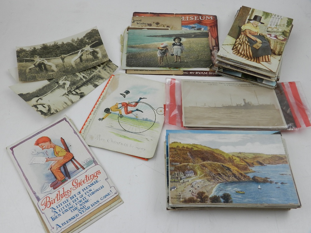 A quantity of early 20th century postcards including three 'naturist' cards together with general