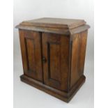 A burr wood table top collectors cabinet, fitted two doors, enclosing two short over one long