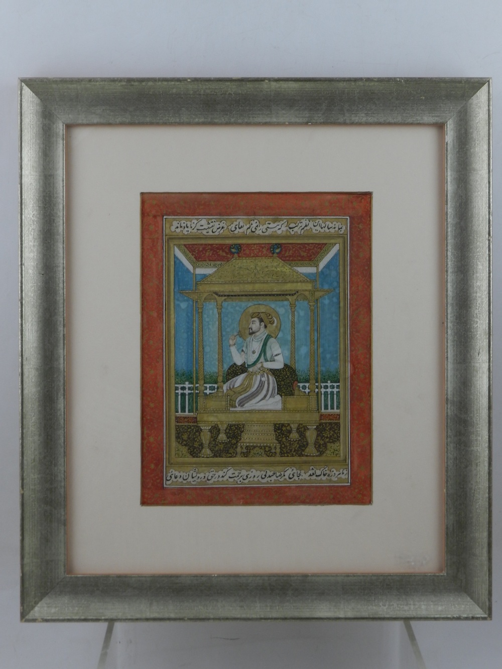 A late 19th / early 20th century Mughal style watercolour, depicting seated noblemen in a pergola.