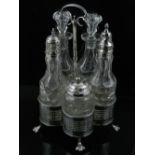 A rare 18th century silver cruet, containing five bottles, raised on paw feet,