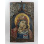 An 18th century Greek icon, The Panagia Glykophilousa, tempera on pine panel, framed within a shaped