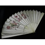 An early 20th century floral painted ivory silk fan, with bone sticks.