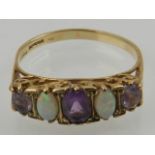 A 9 carat yellow gold, amethyst, and opal five stone ring,