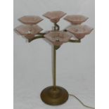 An Art Deco table lamp, having three demi lune shaped braches, each with pink hexagonal glass