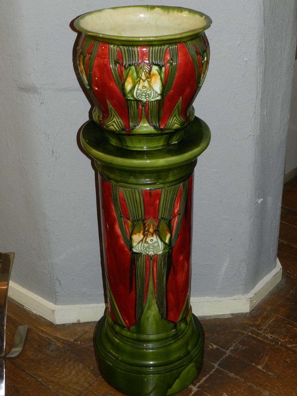 A Minton Seccesionist jardiniere and stand, having tube lined olive green and red decoration, no.