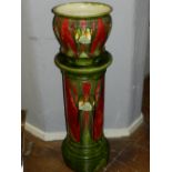 A Minton Seccesionist jardiniere and stand, having tube lined olive green and red decoration, no.