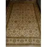 A cream ground Tabriz carpet, overall decorated with traditional scrolling foliate design, within