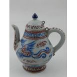 A Chinese blue and white copper glaze teapot, decorated with phoenixes. H.