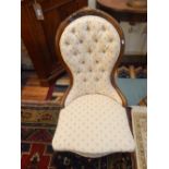 A Victorian spoon back chair, with a button upholstered walnut frame on short cabriole legs