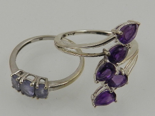 A 9 carat white gold and amethyst crossover ring set five pear-cut stones,