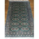 A green ground Bokhara rug,