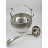 A mid 19th century silver cauldron and ladle, the bowl with swing handle and bright cut design