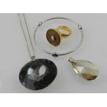 A collection of Swarovski items, to include an unusual cocktail ring, two large crystal pendants,