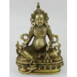 A Tibetan bronze deity, seated on a lotus base. H.