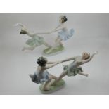 A pair of Continental Art Deco style porcelain figurines depicting dancing ladies holding hands,