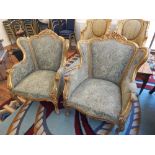 A pair of Louis XVI style gilt framed chairs, with foliate carved top rail and carbriole legs,