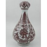 A Chinese baluster vase with garlic head, decorated in copper red with scrolling foliage. H.