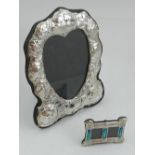 A white metal heart-shaped photograph frame with ornate decoration, stamped 925, together with a