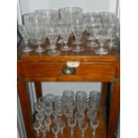 A large quantity of drinking glasses, having vineous wheel cut design, to include drinking glasses,