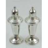 A pair of sterling silver condiments, in the Empire style, having glass liners, boxed.