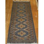 A blue ground Bokhara runner, decorated with 7 hexagonal medallion to centre,