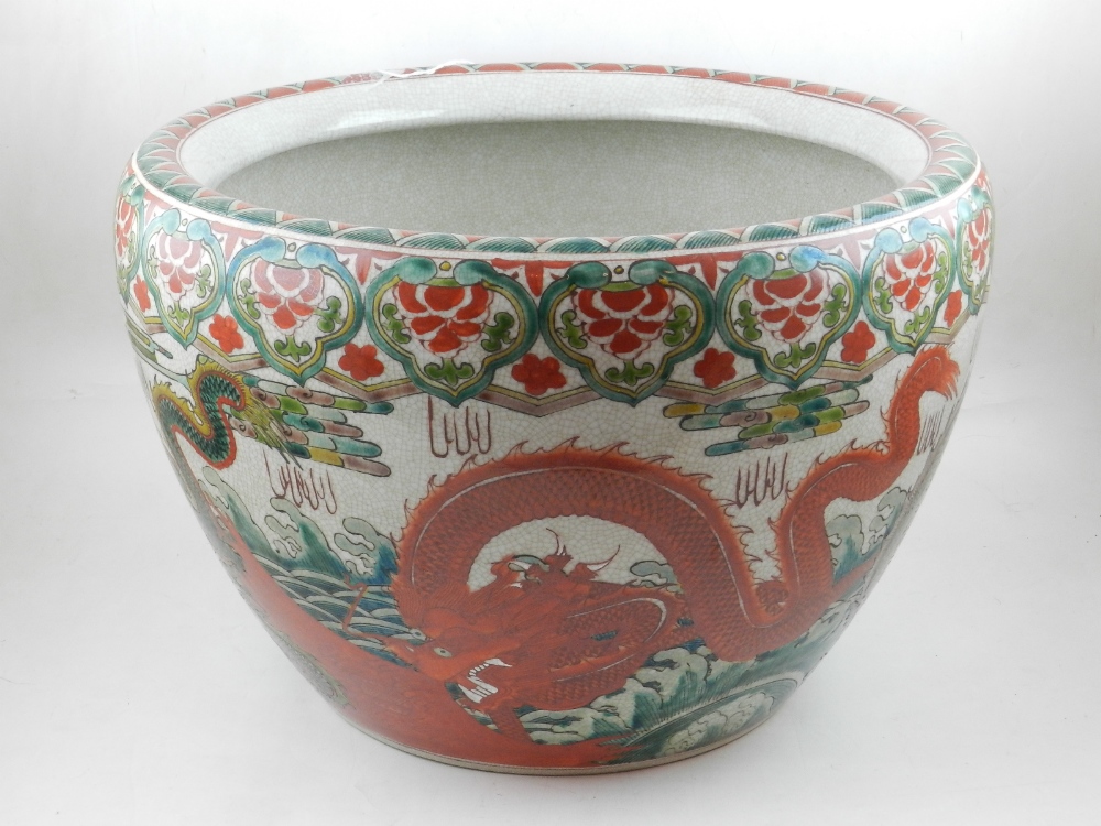 A Chinese porcelain fishbowl, of circular form, with inverted rim, having red and green decoration.