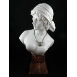 A large ceramic figure of a female, in the Art Deco style, raised on a marble-style stand. H: 54cm