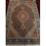 A Kashmiri rug, decorated to centre with lobed tear drop medallion, on a geometric ground,