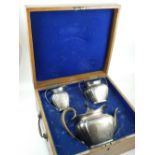 A three piece silver tea set, London 1903, having gilt washed interior,