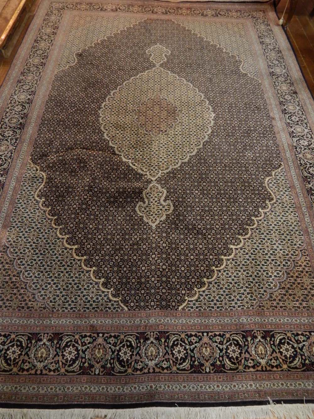 An Indigo ground Tabriz carpet, decorated with tear drop medallion to centre,