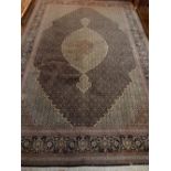 An Indigo ground Tabriz carpet, decorated with tear drop medallion to centre,