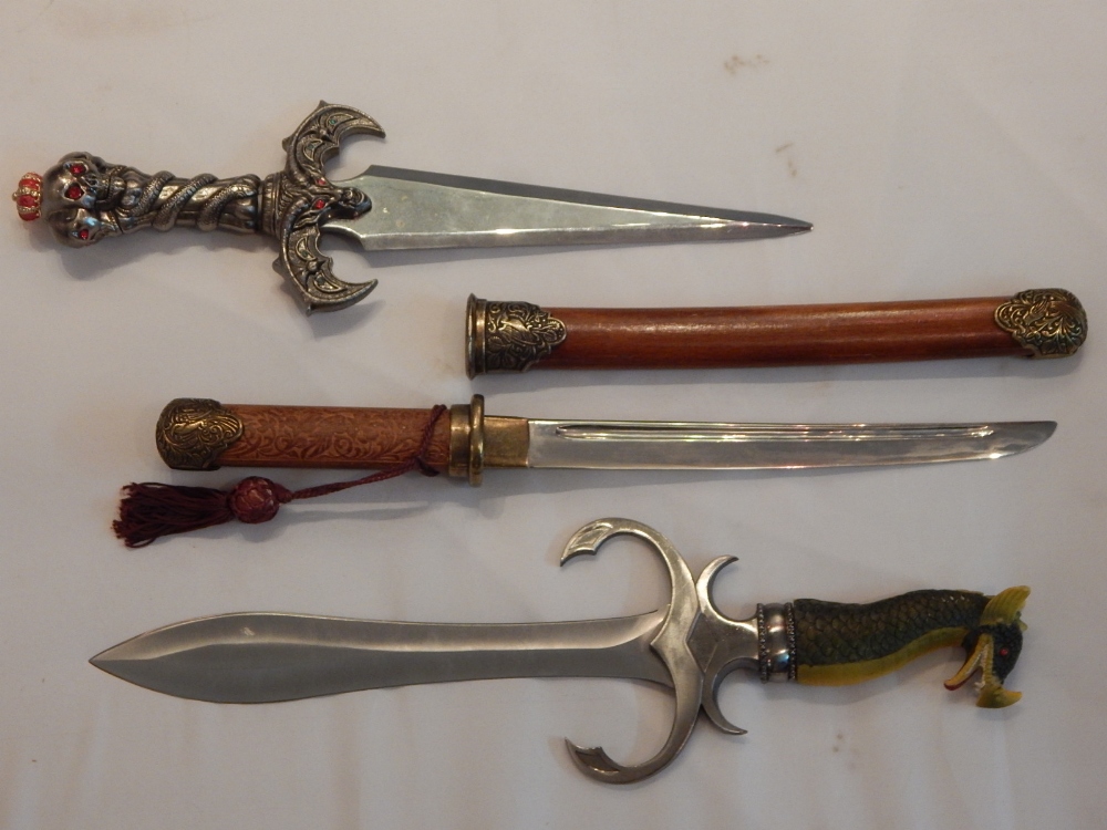 Three various novelty swords.