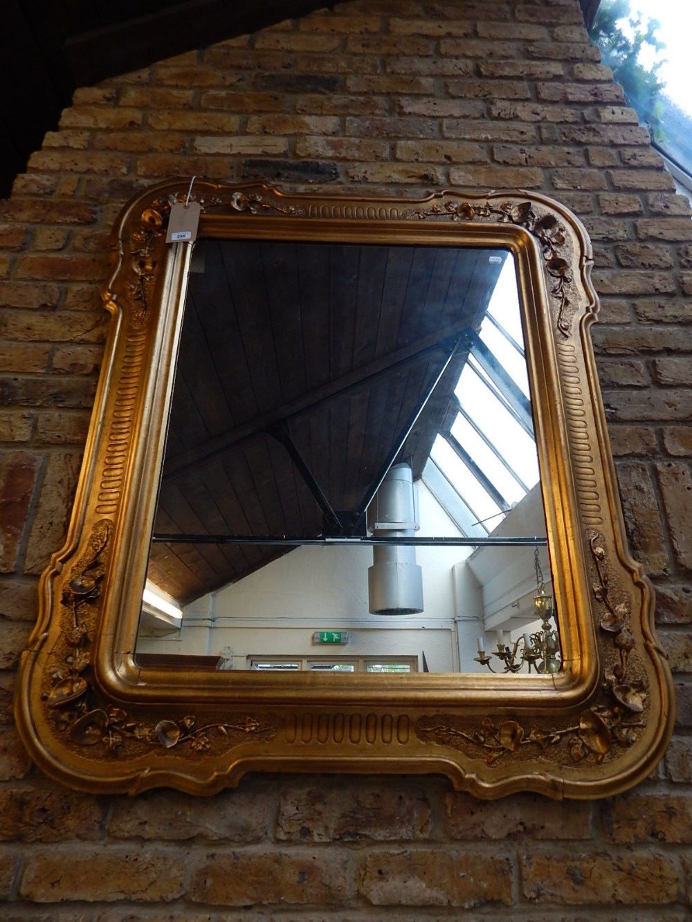 A 19th century gilt framed wall mirror, the rectangular plate within a composition frame, 120cm.