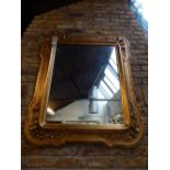 A 19th century gilt framed wall mirror, the rectangular plate within a composition frame, 120cm.