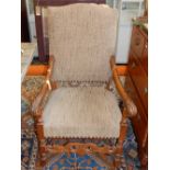 A 17th century style oak arm chair, with an upholstered pad back,