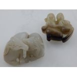 A jadeite carving of a couple in an erotic embrace, together with another jadeite carving,