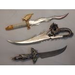 Three various novelty swords, having stainless steel blades.