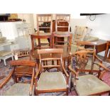 A set of three late George III mahogany dining chairs, with rail backs and solid contoured seats,