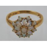 A 9 carat yellow gold and opal cluster ring.