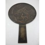 A 19th century Chinese bronze mirror, of paddle form, decorated with cranes and tortoise. H.