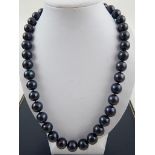 A black South Sea pearl necklace, having white metal metallic ball clasp.