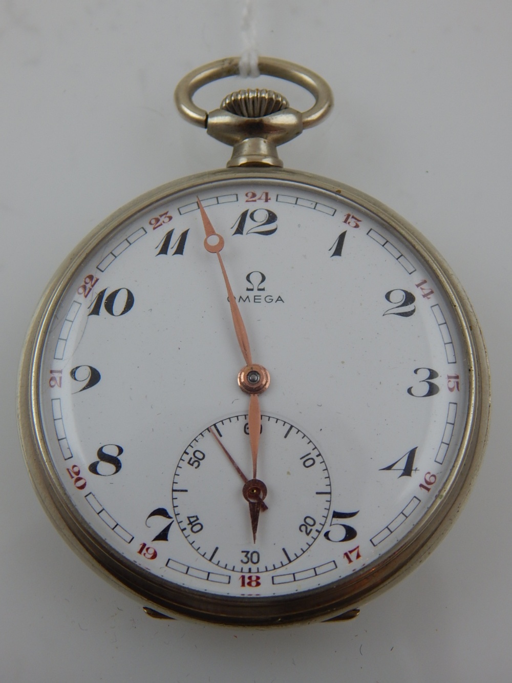 A stainless steel Omega open faced pocket watch, the enamel dial with Arabic numerals,