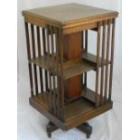 A 1920s oak revolving bookcase, on quadruple platform foot. H.