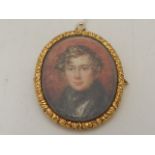 A 19th century yellow metal mounted pendant brooch, set portrait miniature,