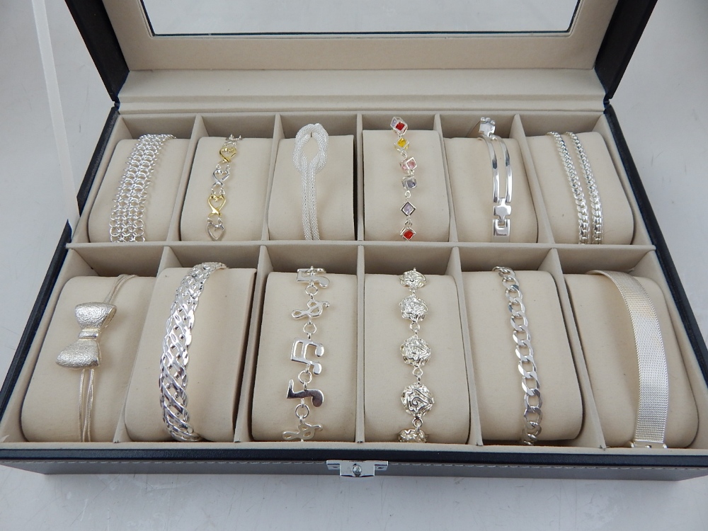 A quantity of twelve white metal bracelets, of various design,