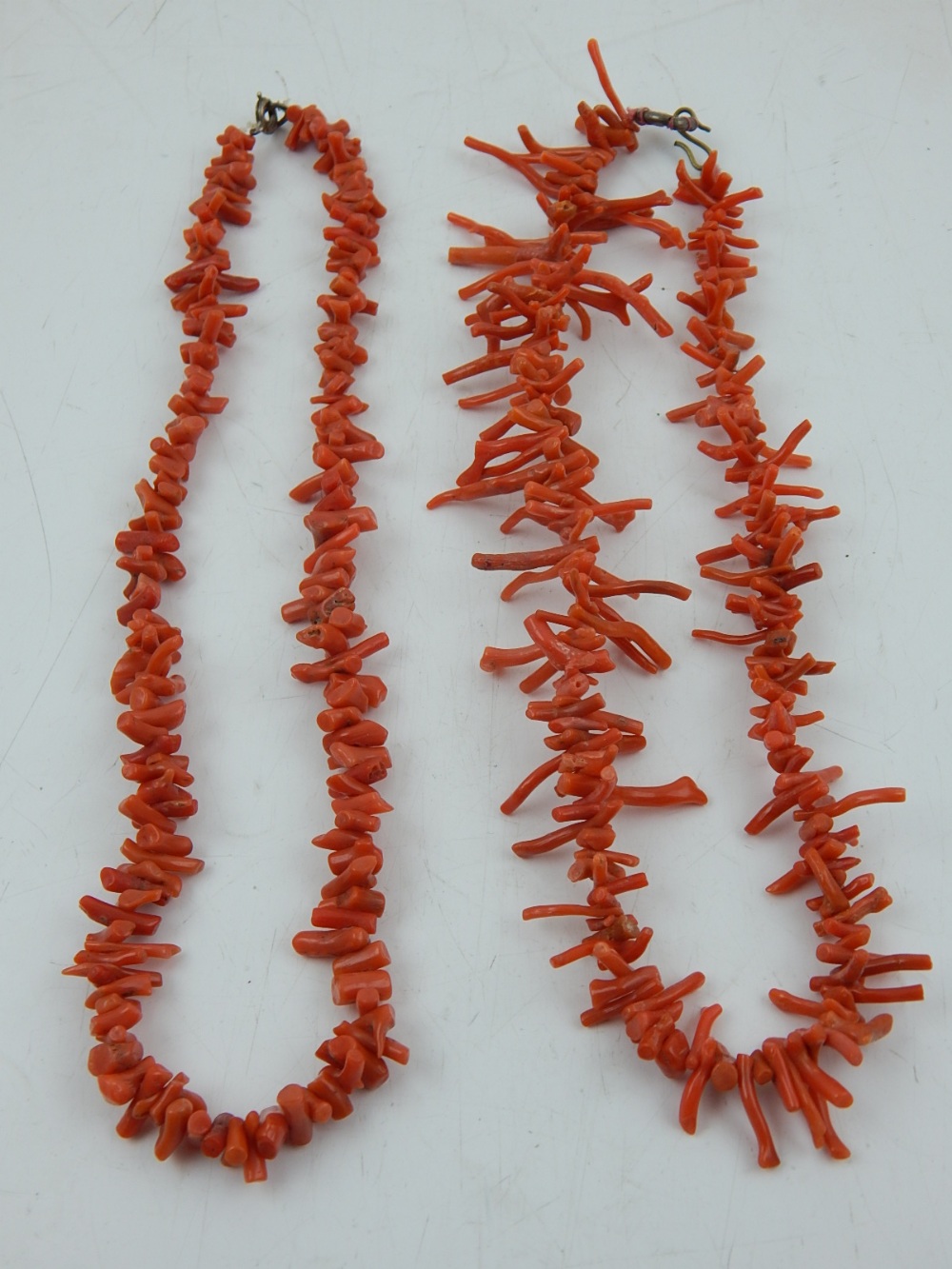 Two Chinese coral necklaces, circa 1920s.