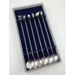 A set of six Japanese white metal cocktail spoons, having leaf engraved bowls,